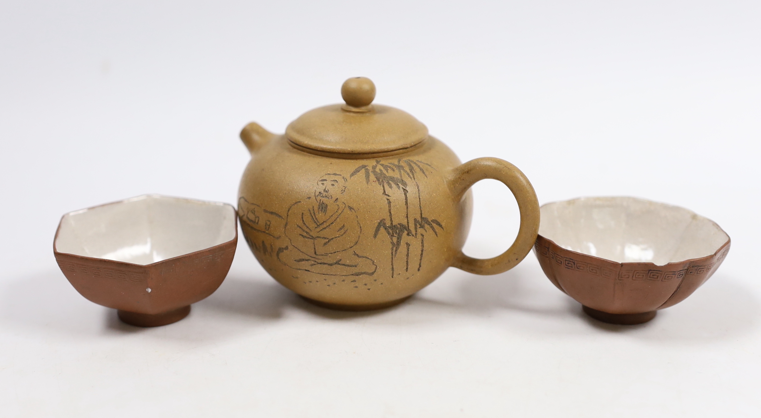 A Chinese Yixing teapot, seal mark to base and two enamelled cups